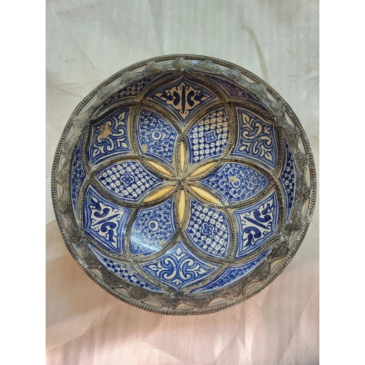 Large white metal-mounted  ceramic plate