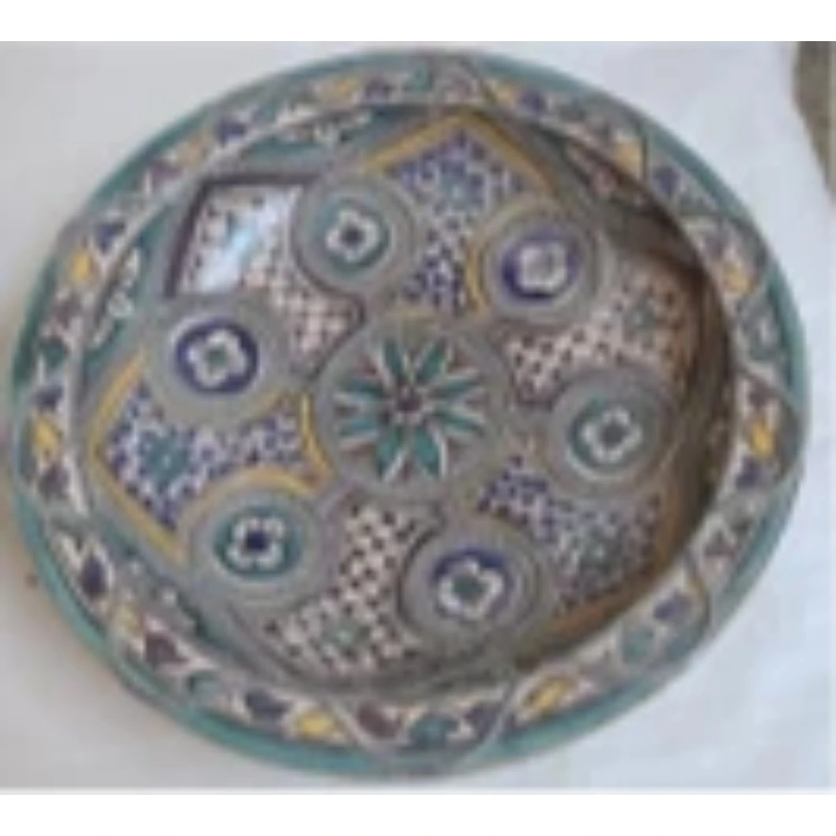 Large white metal-mounted ceramic plate